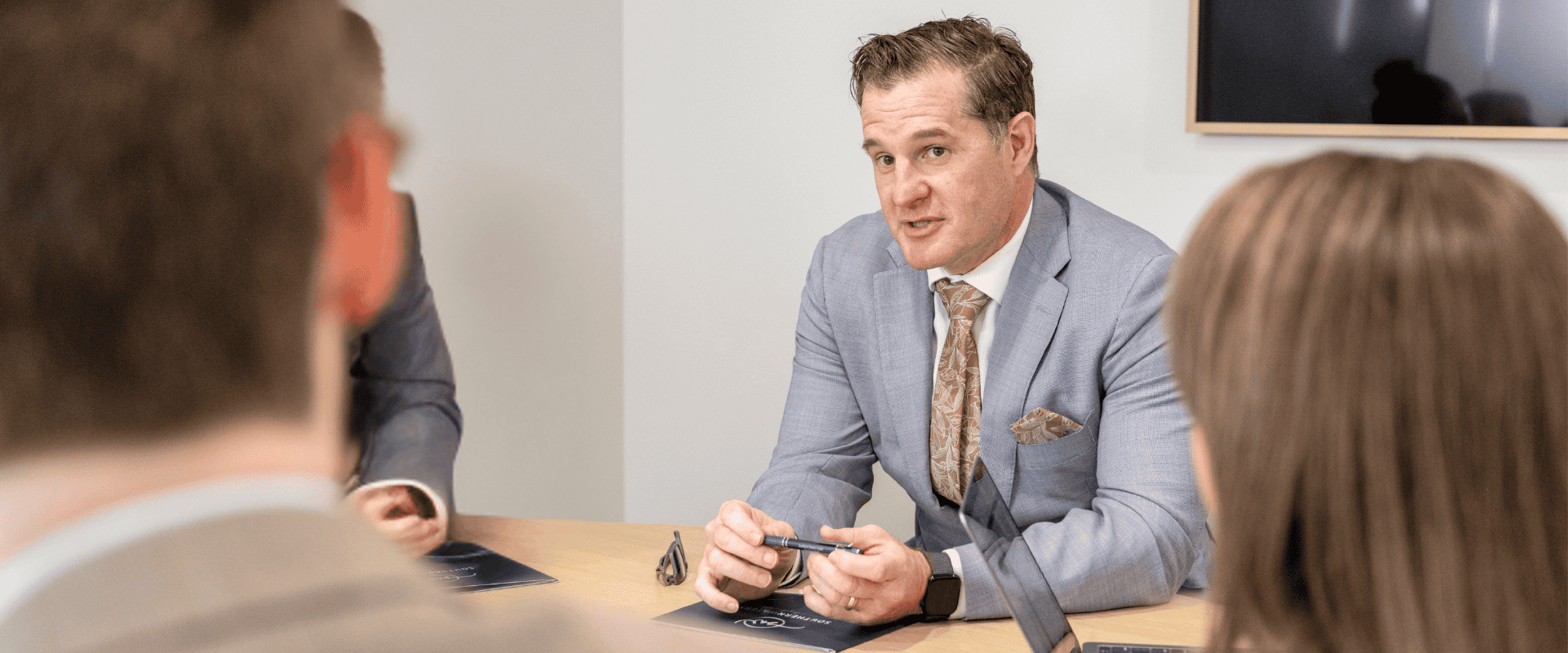 A Southern Waters Legal estate planning and litigation lawyer meeting with clients to discuss contesting or defending a will.